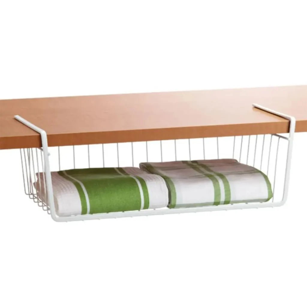 "Undershelf storage basket attached to a wooden shelf, holding neatly folded green and white kitchen towels. Ideal for maximizing storage space in cabinets and countertops