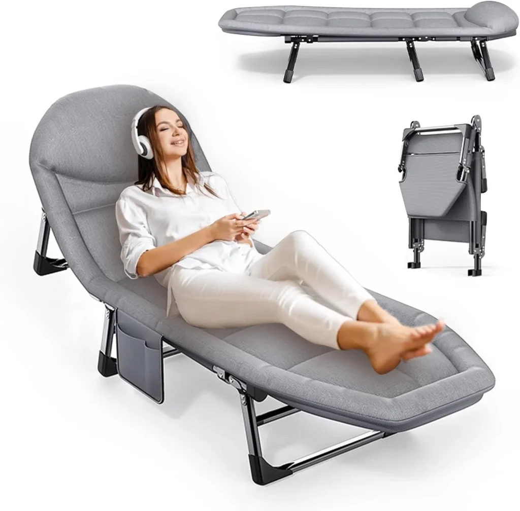Woman relaxing on a plush gray folding camping cot with a headrest, listening to music on headphones. The cot folds up for easy storage and transport, perfect for camping or guest accommodations.